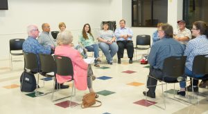 Adoptive parents and foster parents at a support group meeting in Arms Wide
