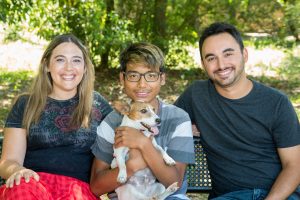 Teenager with his foster parents and their dog