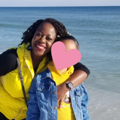 Single foster mom enjoys the beach with her daughter in matching yellow shirts